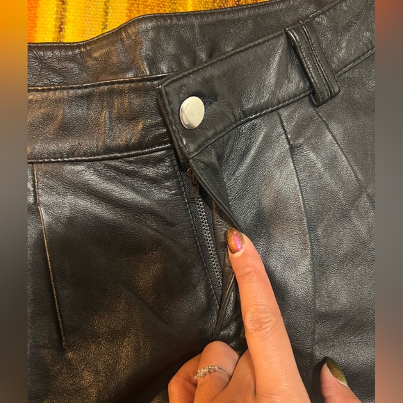 Genuine leather black mini shorts lined with silver metal grommets. Size 8 - Picture 3 of 7